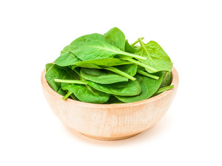 spinach leaf in wooden bowl isolated on white background