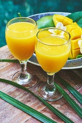Glasses of fresh tropical smoothie or mango juice
