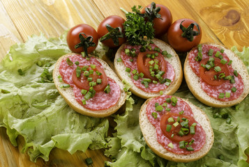 Sandwich with sausage and tomatoes.