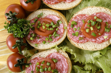Sandwich with sausage and tomatoes.