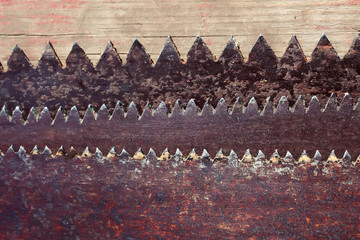 the sharp teeth of rusted old metal saws