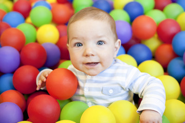 baby boy playing in the playground balls pool