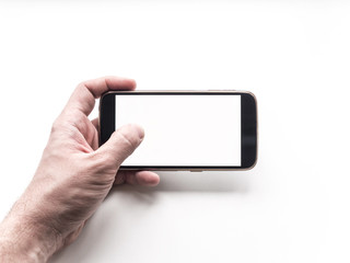 Hand holding mobile smartphone with blank screen on white background