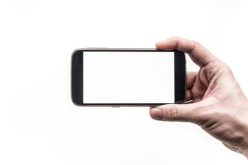 Hand holding mobile smartphone with blank screen horizontally on white background
