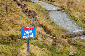 Warning Sign on a Mountain Path