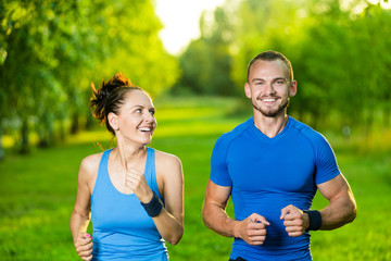 Fototapeta premium Runners training outdoors working out. City running couple jogging outside. 
