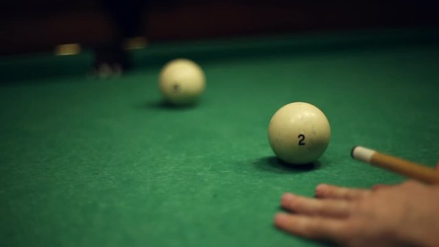Billiards table and balls, strike the cue ball and falling in the pocket
