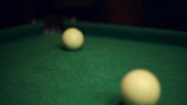 Billiards table and balls, strike the cue ball and falling in the pocket
