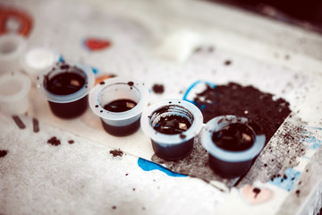 A special paint for doing the tattoo. Preparation of master tattoo artist to work