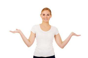 Fototapeta premium Young woman presenting something on open palms