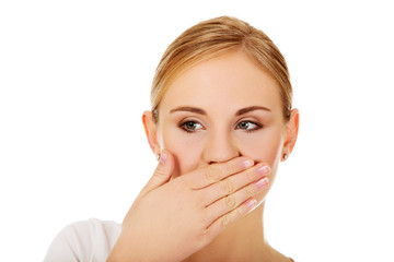 Young woman covering her mouth with hand