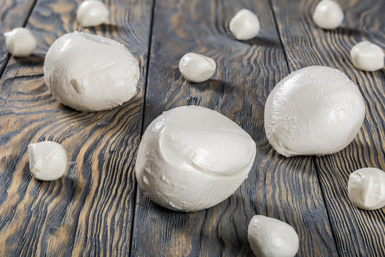 mozzarella balls on a wooden table, close-up