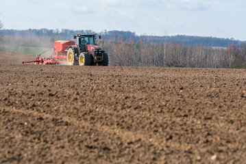 Tractor harrowing the field