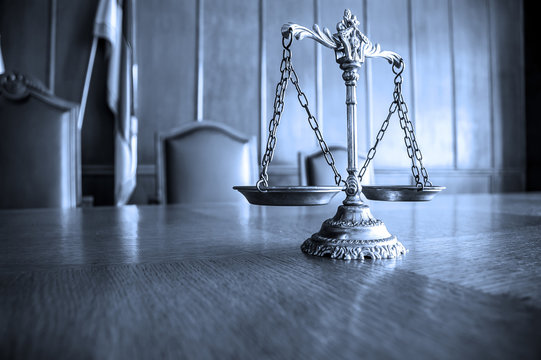 Decorative Scales of Justice on the table. Focus on the scales, BLUE TONE