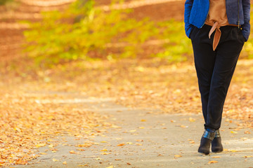 Obraz premium Fashionable girl walking in park.