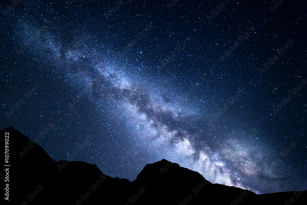 Wall mural mountain landscape with blue milky way. night sky with stars and rocks at summer. beautifu universe