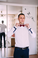 Groom is preparing for his wedding in the morning