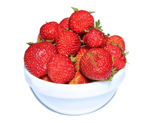 Juicy red strawberries in a white saucer