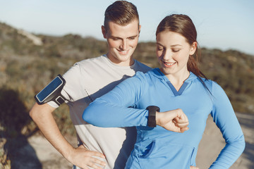 Runner woman with heart rate monitor running on beach