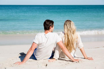 Romantic young couple sitting on the beach