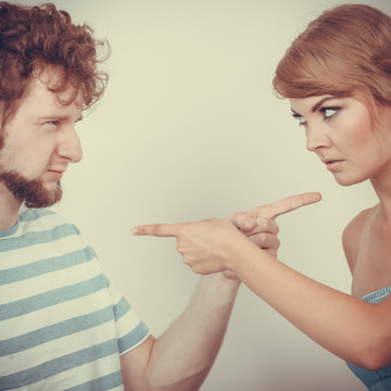 couple pointing fingers at each other, conflict