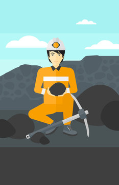 Miner holding coal in hands.