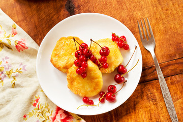 Sweet breakfast from cheesecakes with fresh berries on the table