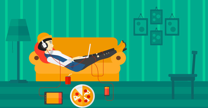 Woman lying on sofa with many gadgets.