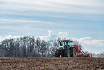 Tractor harrowing the field