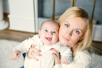 a small child in the arms of mom . positive human emotions,
