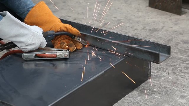 Worker uses gas metal arc welding (especially metal inert gas or MIG welding) to fix the workpieces