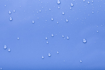 Dops of water on a color background. Blue. Toned