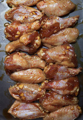Marinated chicken wings on a black pan