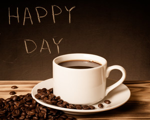 Romantic theme on a chalkboard behind a wooden table with cup of