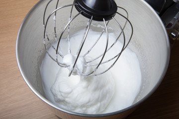 The process of whipping egg whites in a planetary mixer
