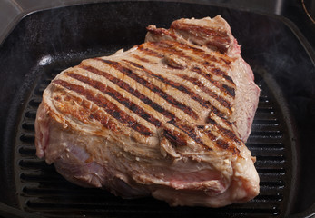 Large piece of fresh beef meat prepared on a grill pan