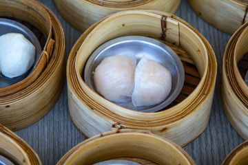 various dim sum in bamboo steamer in chinese restaurant