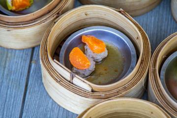 various dim sum in bamboo steamer in chinese restaurant