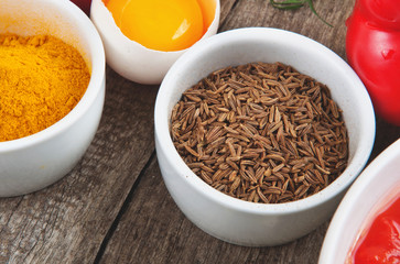 cumin seeds in white bowl with foodstuffs