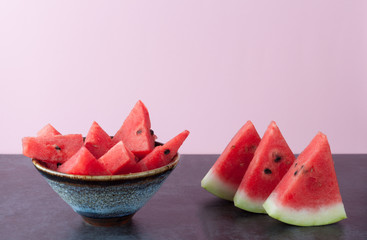 Watermelon slices on dark grungy surface  with copy space. Shallow depth of field.