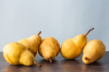 Five whole yellow Corella pears. Horizontal image with copy space.