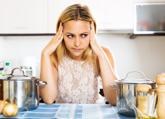 Confused housewife in the kitchen
