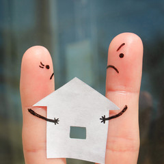 Finger art of family during quarrel.  Concept of man and woman can not divide house after divorce.