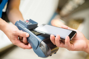 Customer using cellphone for pay by NFC technology
