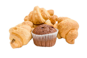 Several small croissant and chocolate muffin on a light backgrou