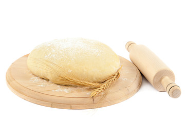 Dough on the wooden board.