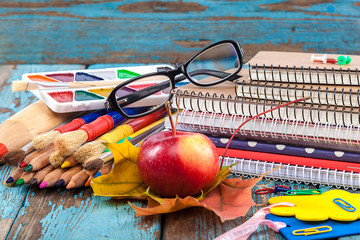 Office or school supplies on wooden planks