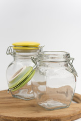 Two empty glass jars on the wooden board