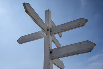 white guidepost with blue sky