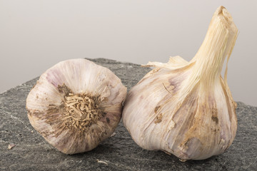 Fresh garlic on stone background